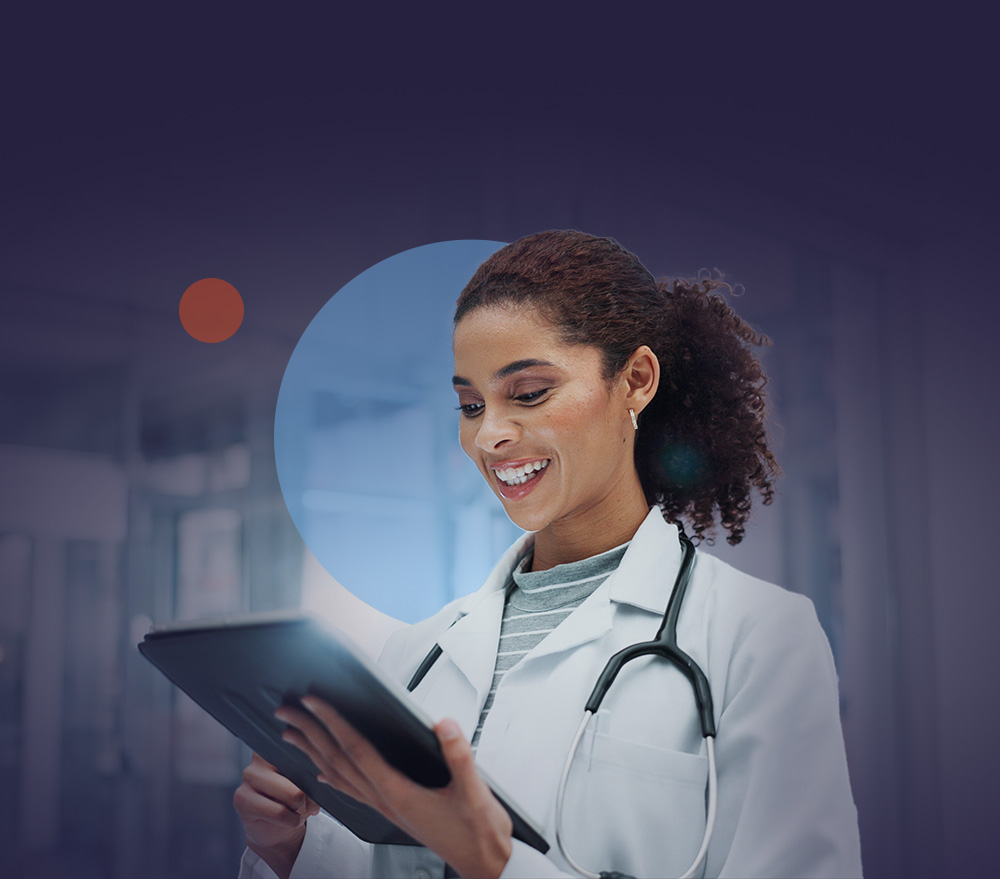 Doctor smiling while reviewing a tablet