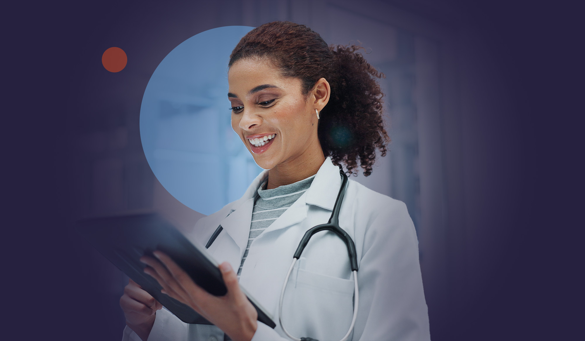 Doctor smiling while reviewing a tablet